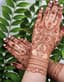 Floral Adornment: Intricate Henna Hands for a Haldi Blessing