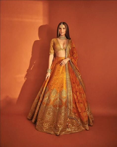Gilded Sunset: An Orange Lehenga Radiating Bridal Warmth