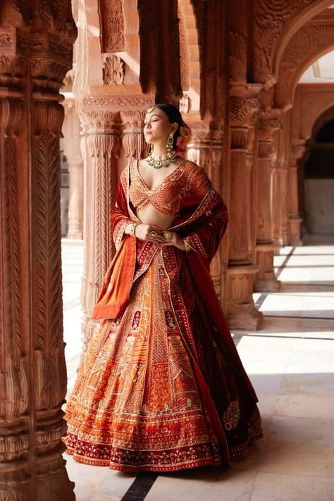 Crimson Sunset: Regal Bridal Lehenga in Marigold Hues
