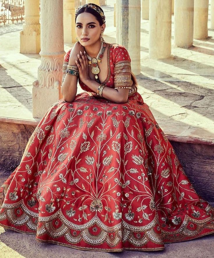 Crimson Bloom: A Regal Bridal Lehenga in Amber Light